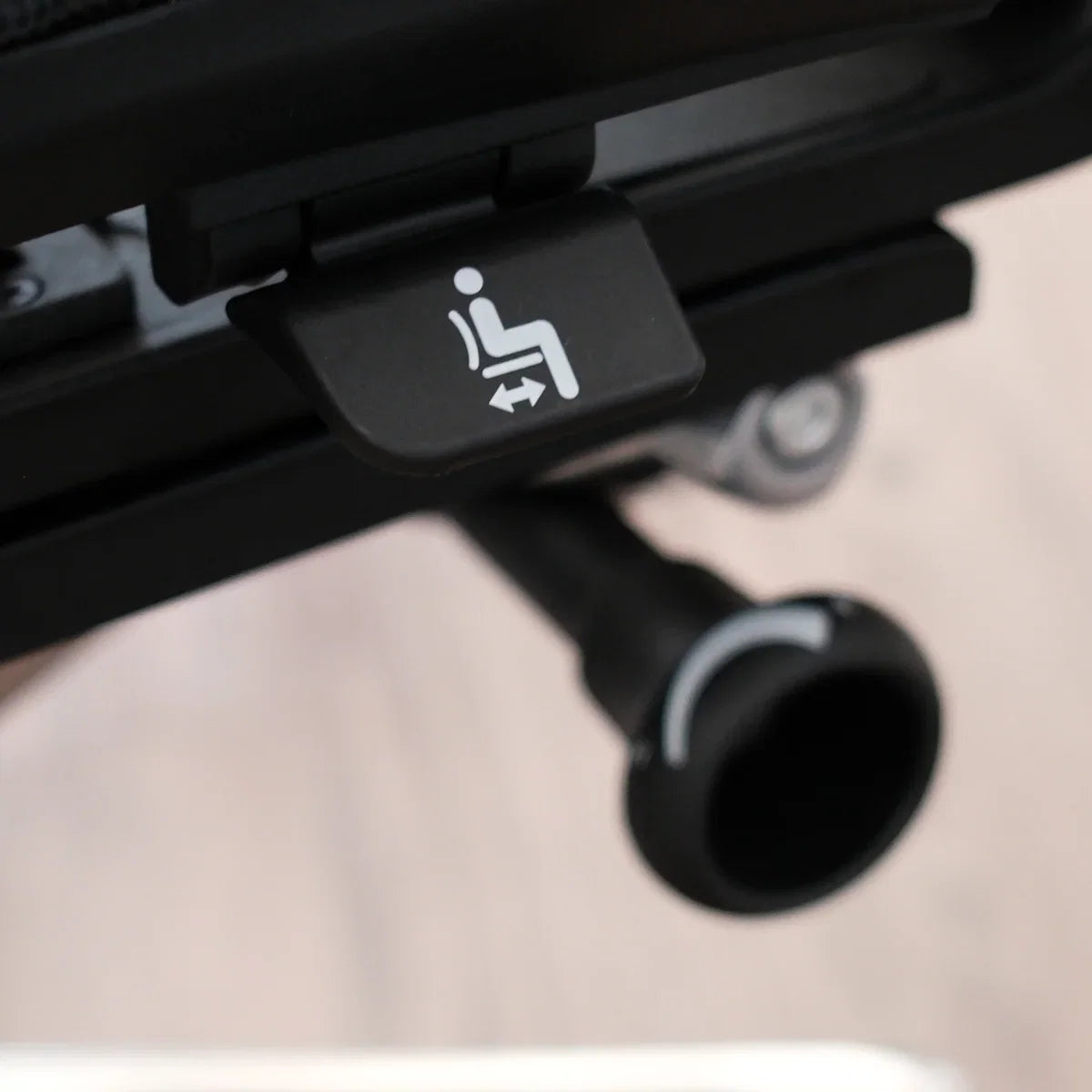 Close view of a round control and marked paddle beneath an OdinLake O3 chair seat