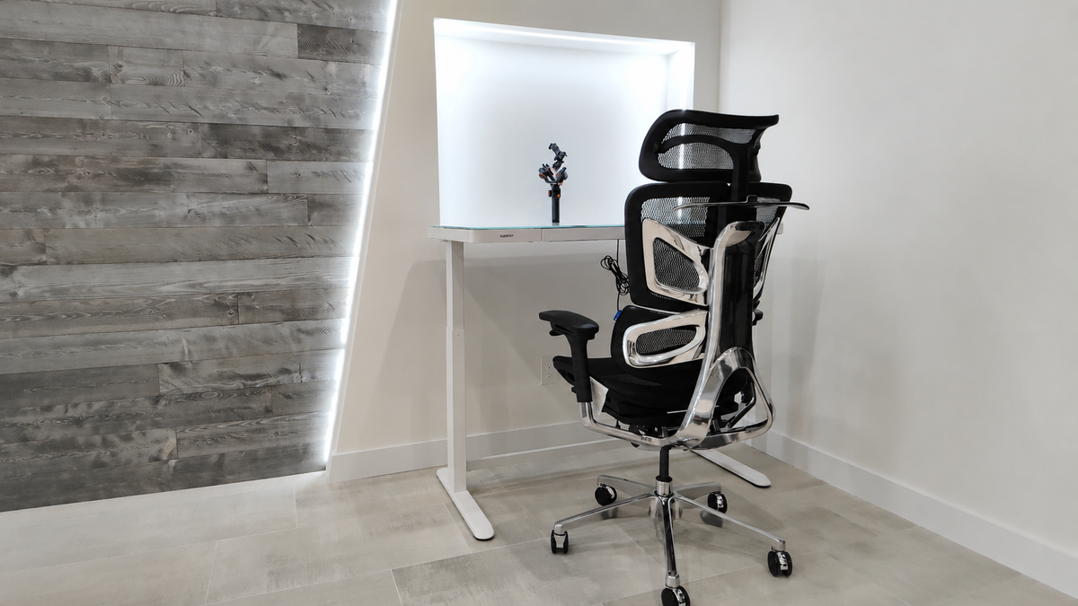 Person sitting comfortably in an OdinLake ergonomic chair at a modern home office desk