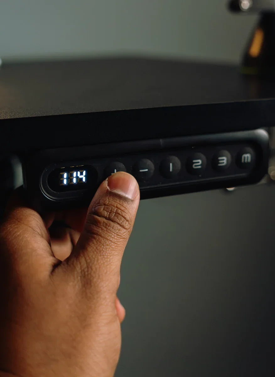 Close view of a hand using an OdinLake standing desk control panel