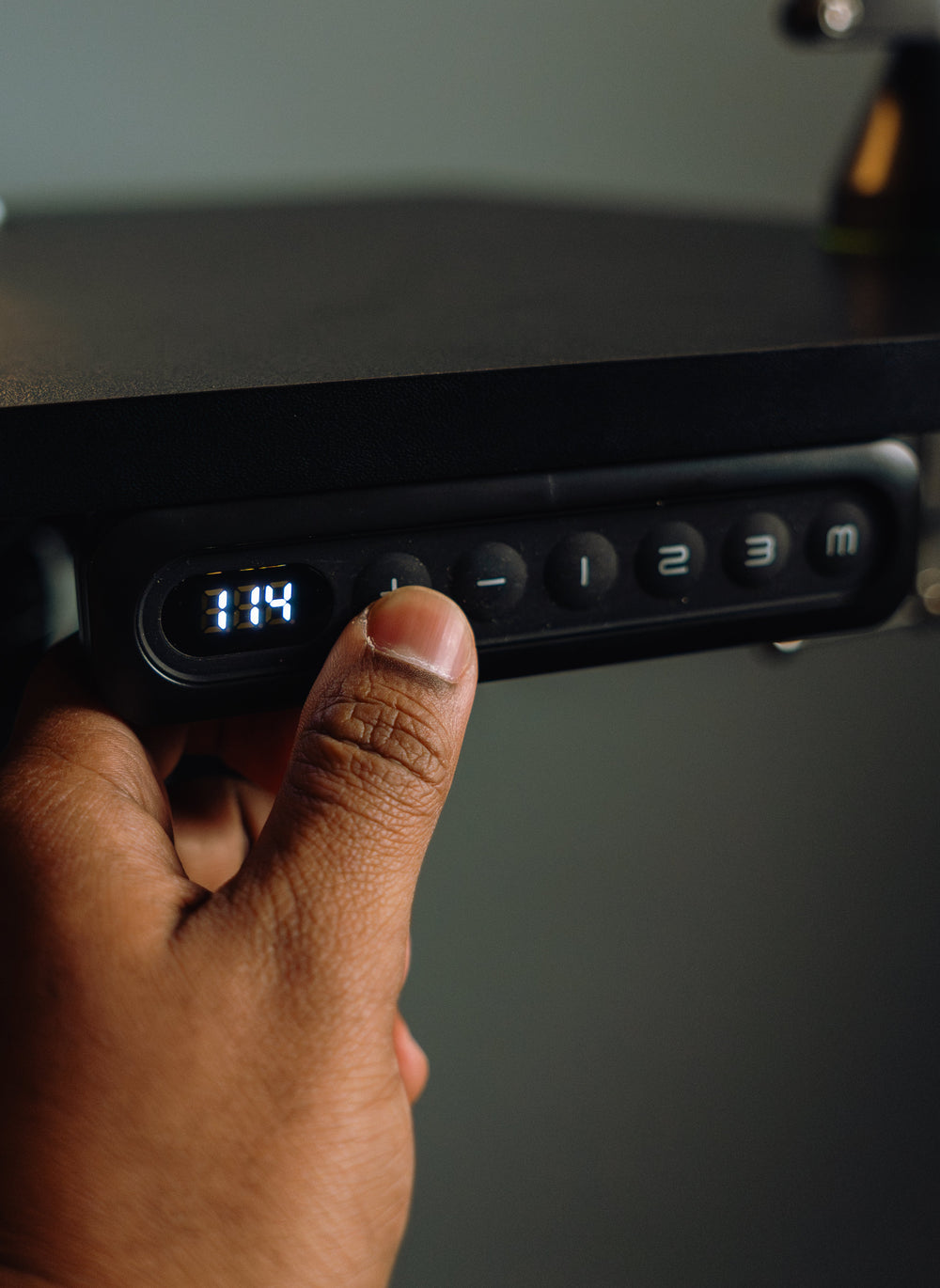 Close view of an OdinLake standing desk memory handset showing height and preset controls